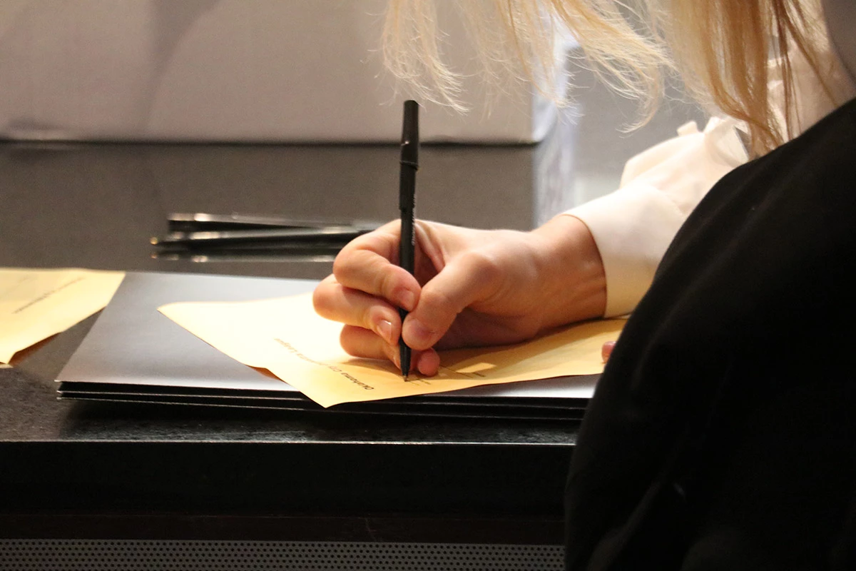 Woman fills out form.