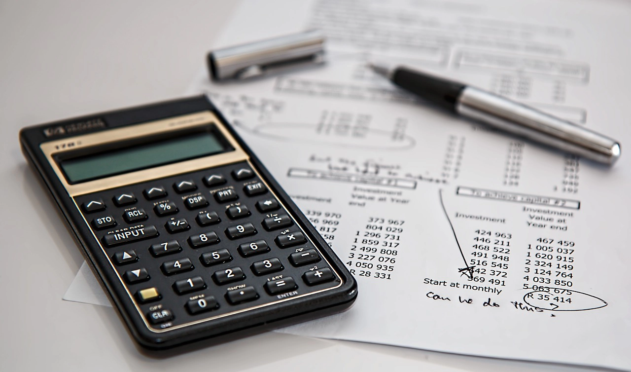 Calculator with pen and budgeting materials